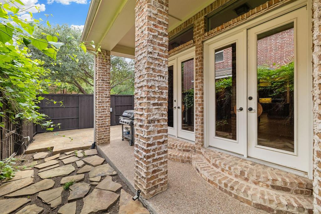 18231 Brighton Green Dallas, TX 75252 - Photo 36 of 36 a view of a porch with a table and chairs and wooden fence
