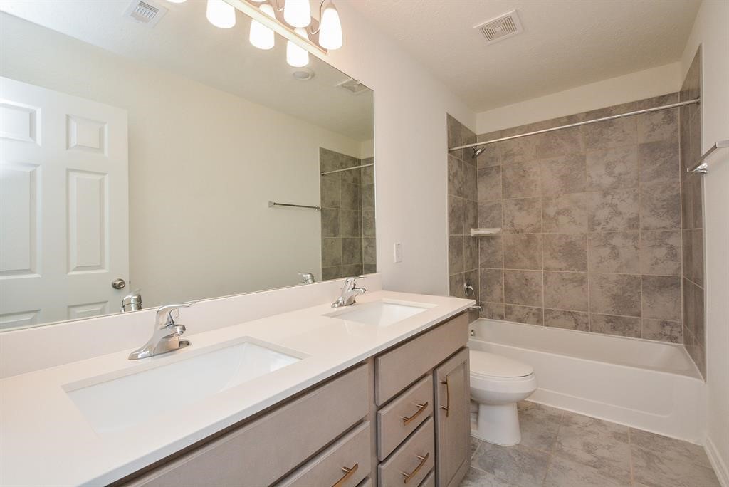 4542 Medrano Trail Katy, TX 77449 - Photo 6 of 10 a bathroom with a sink a toilet and shower