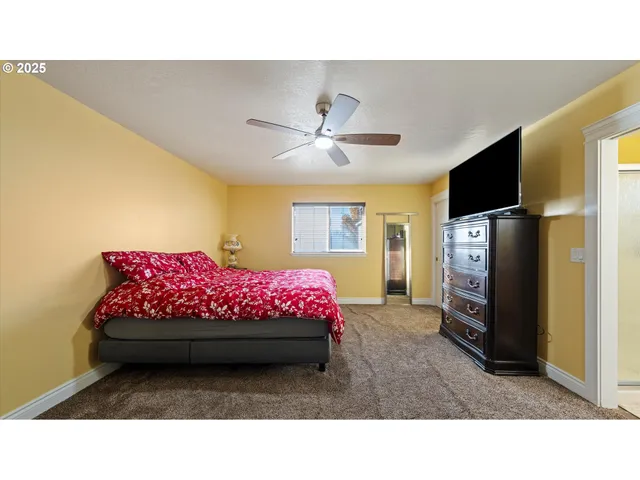 a bedroom with a bed and a flat screen tv