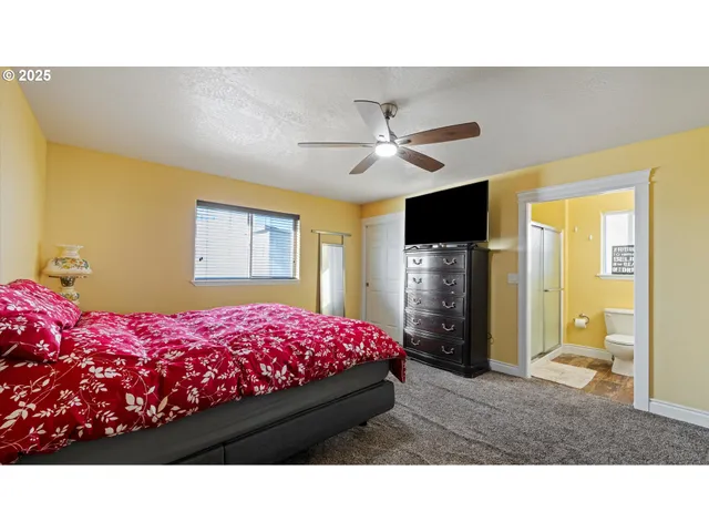 a room with a bed dresser and a large mirror