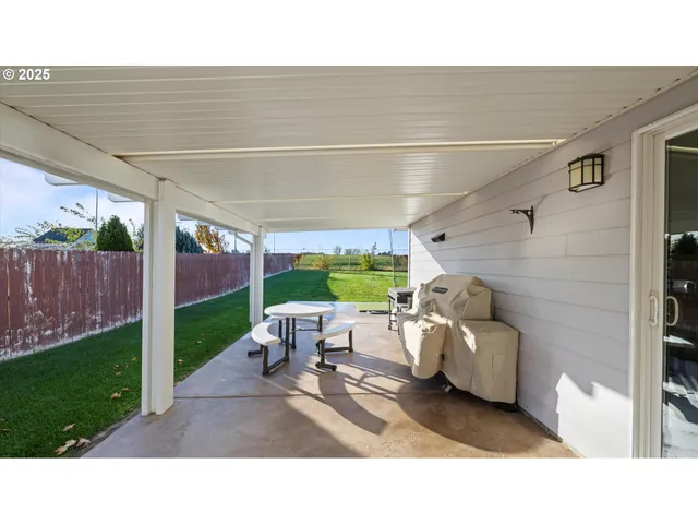 a backyard of a house with outdoor seating