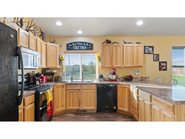 a kitchen with stainless steel appliances a sink stove and cabinets