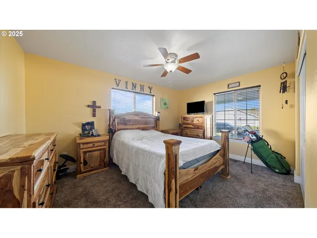 a living room with a bed furniture and a flat screen tv