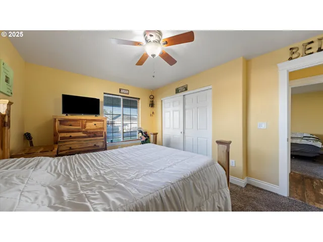 a bedroom with a bed and a flat screen tv