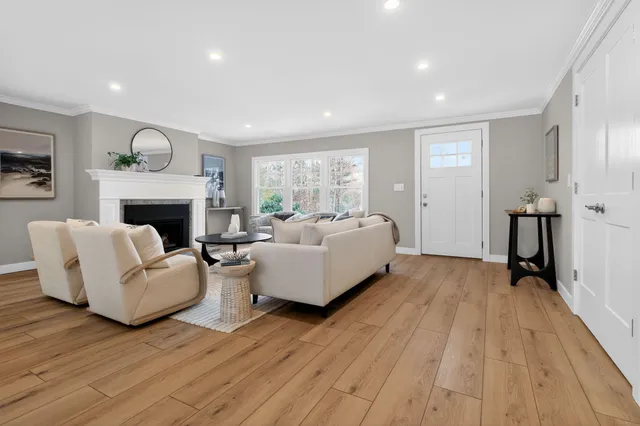 a living room with furniture and a view of kitchen