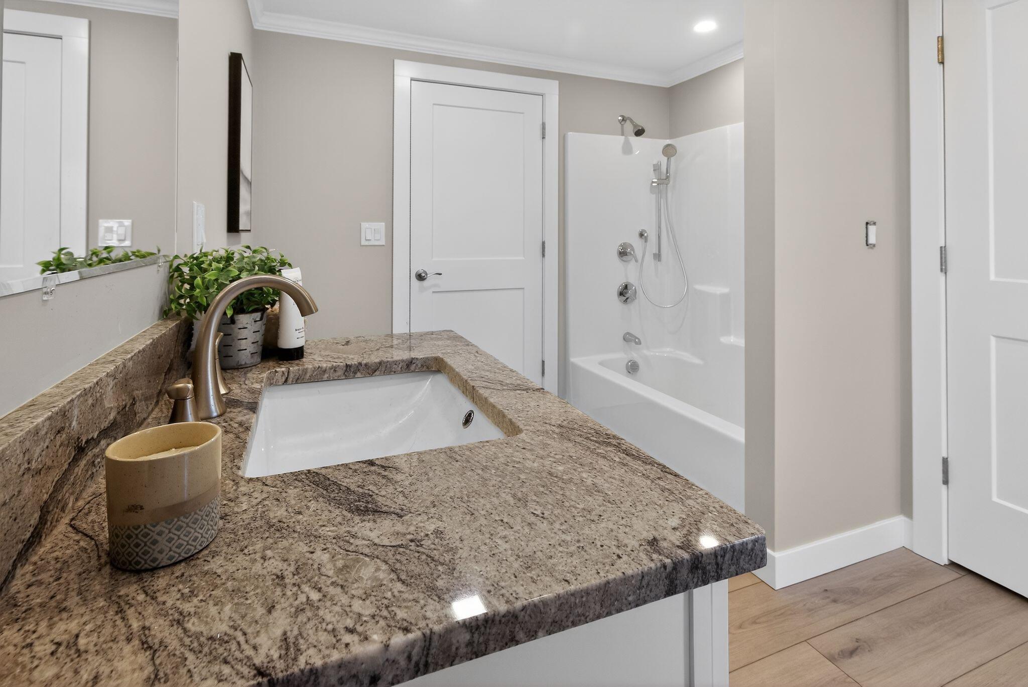 53 Eel River Road East Falmouth, MA 02536 - Photo 40 of 42 a bathroom with a granite countertop sink a toilet and bathtub