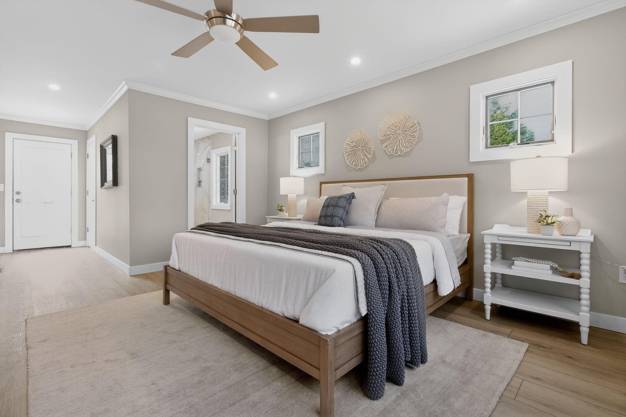 53 Eel River Road East Falmouth, MA 02536 - Photo 7 of 42 a spacious bedroom with a bed and a chandelier