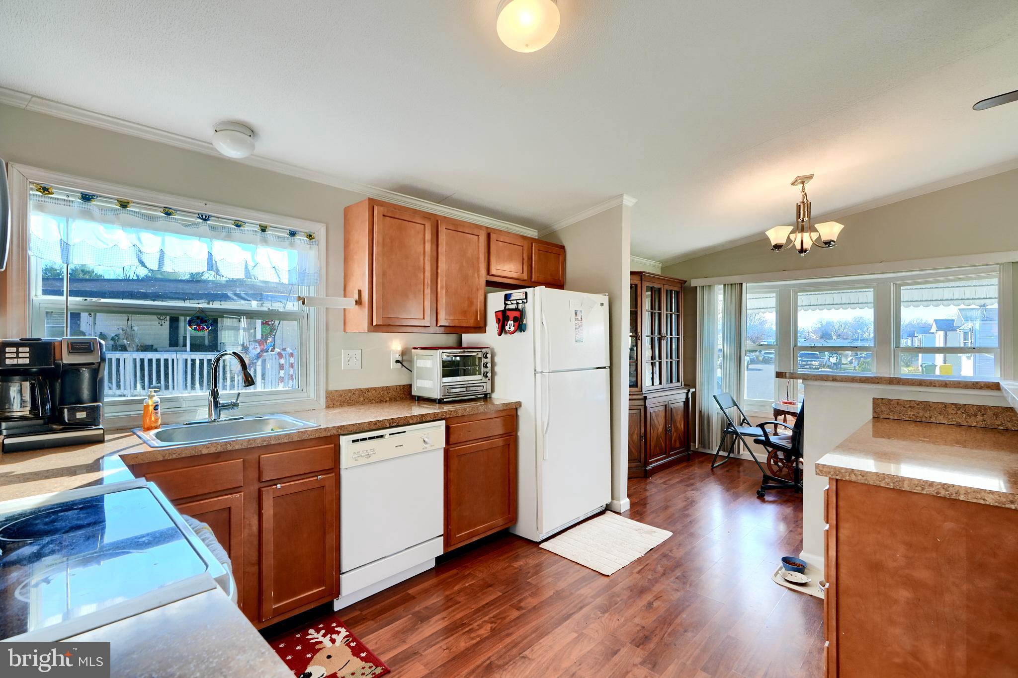 127 Cowhide Circle Baltimore, MD 21220 - Photo 13 of 27 a kitchen with stainless steel appliances granite countertop a refrigerator a stove top oven a sink dishwasher and white cabinets with wooden floor