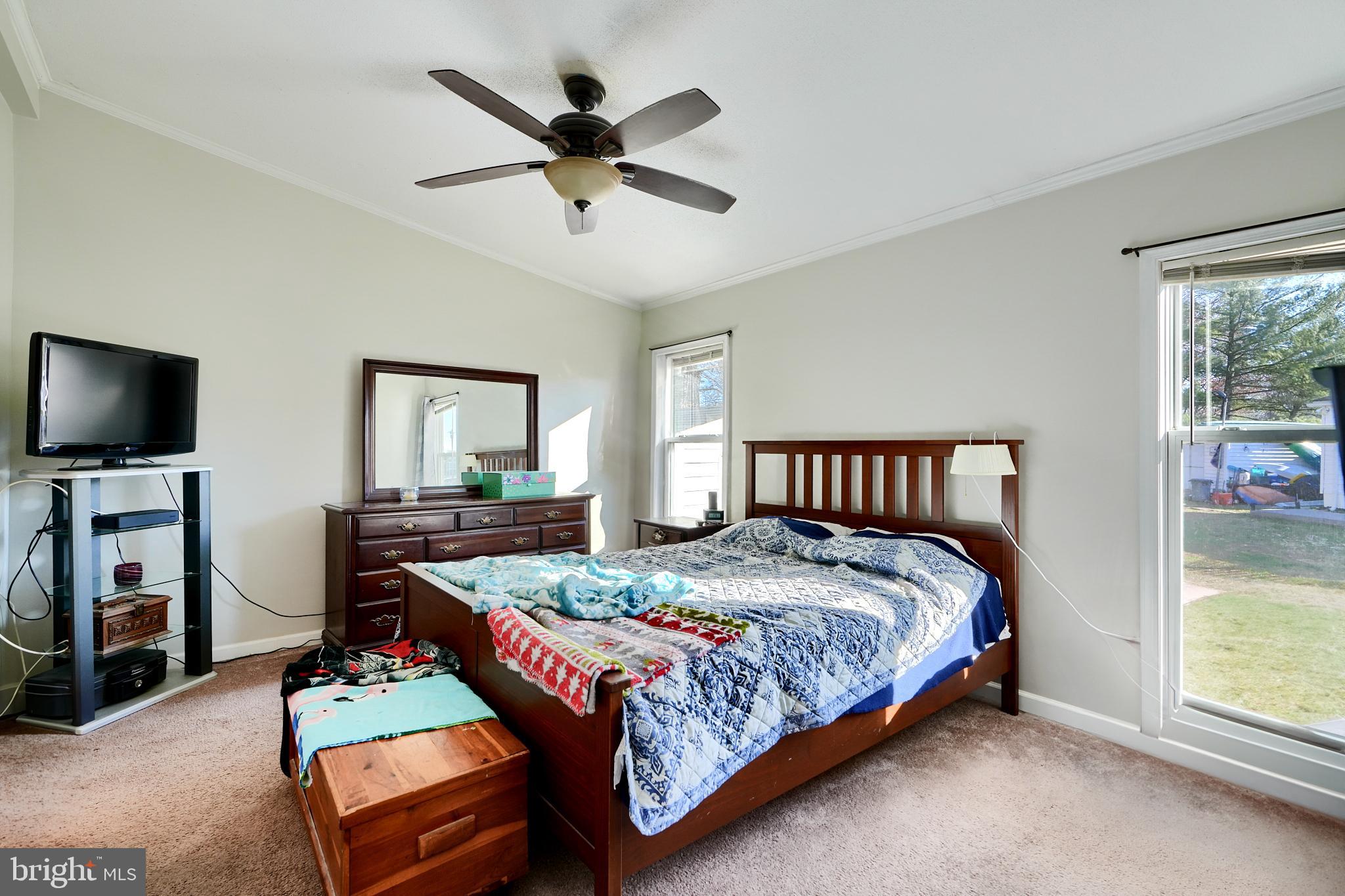 127 Cowhide Circle Baltimore, MD 21220 - Photo 21 of 27 a bedroom with a bed a dresser and a flat screen tv