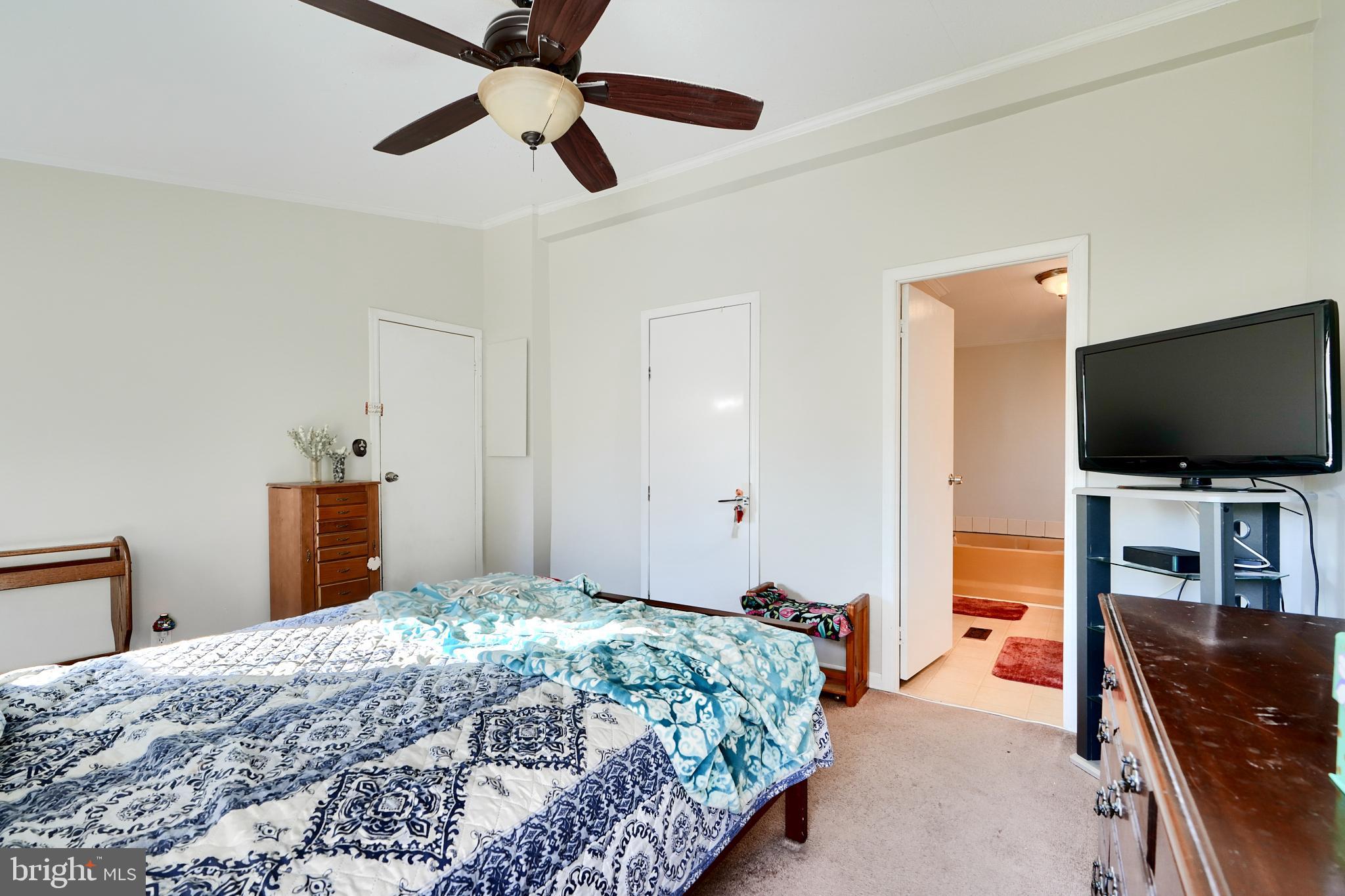 127 Cowhide Circle Baltimore, MD 21220 - Photo 22 of 27 a bedroom with a bed and a flat screen tv