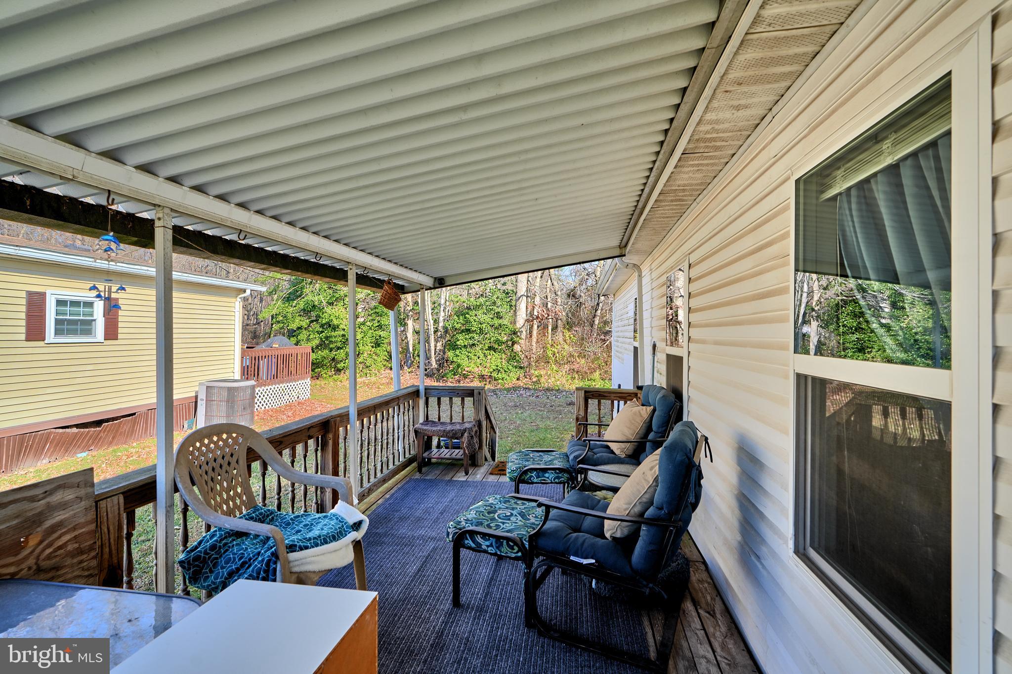 127 Cowhide Circle Baltimore, MD 21220 - Photo 3 of 27 a view of a patio with chairs and wooden floor