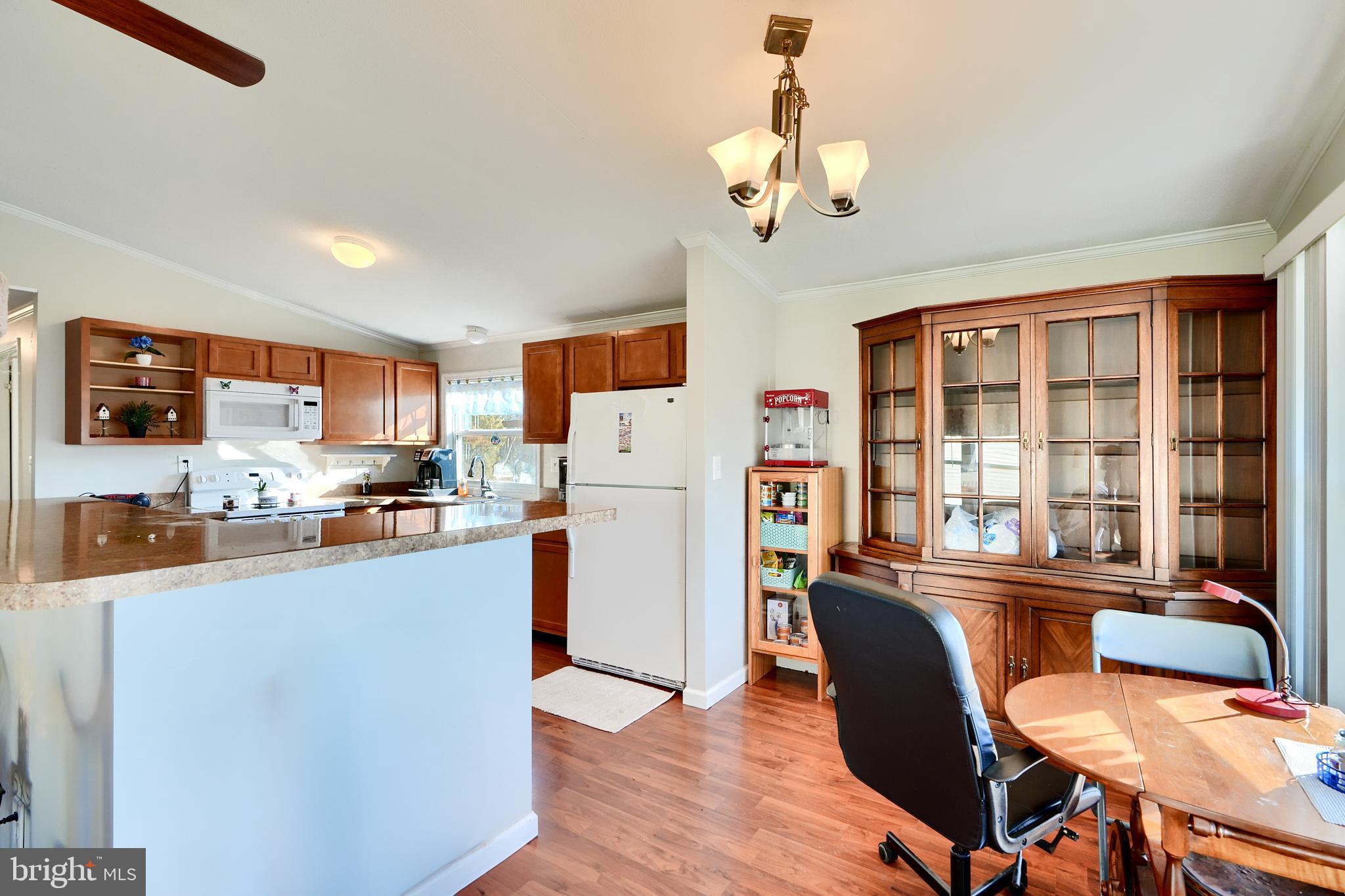 127 Cowhide Circle Baltimore, MD 21220 - Photo 7 of 27 a dining room with stainless steel appliances wooden floors and large windows