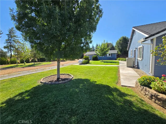 a view of a backyard with swimming pool