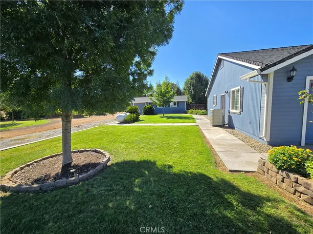 a swimming pool with outdoor seating and yard