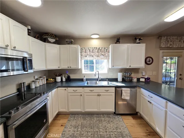 a kitchen with a sink stove top oven and cabinets