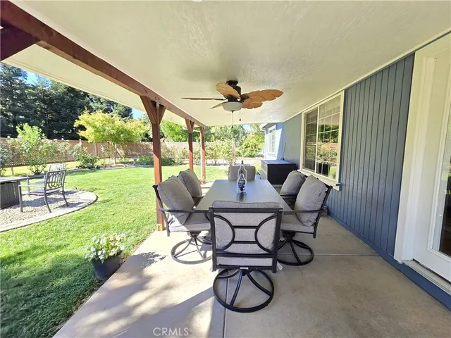 a view of a house with a yard and sitting area