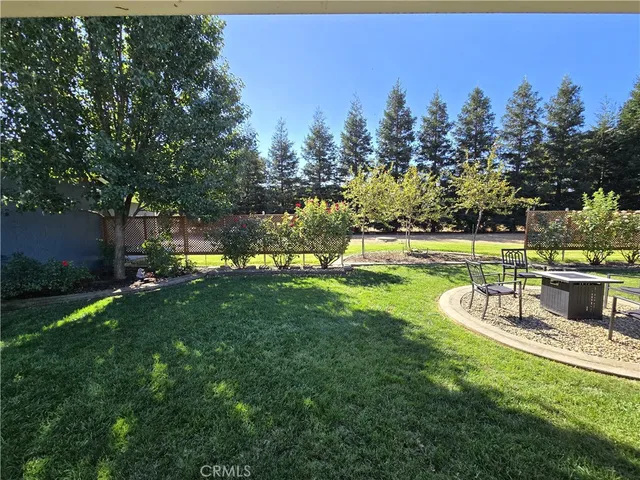 a view of a house with backyard sitting area and furniture