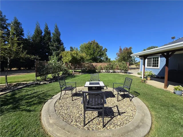 a view of backyard with swimming pool and outdoor seating