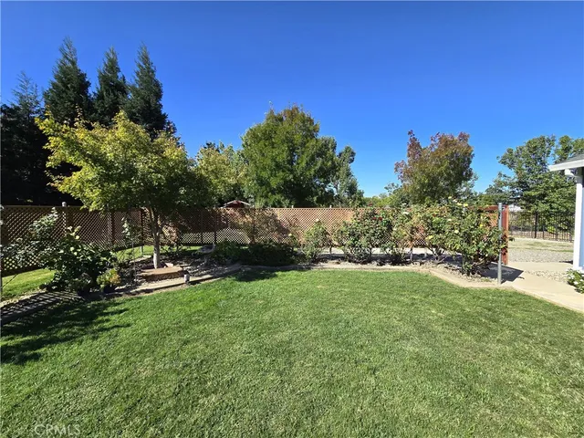 a backyard of a house with yard and trampoline