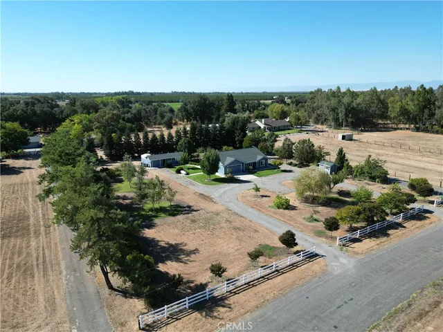 an aerial view of a house with a yard and lake