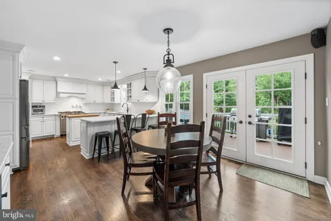 a view of a dining room with furniture large windows and wooden floor
