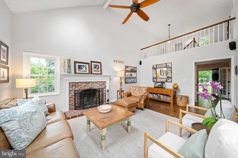 a living room with furniture fireplace and window