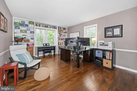 a view of a room with wooden floor and windows