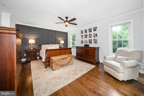 a bedroom with a bed couch and window
