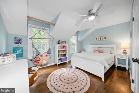 a bedroom with a bed closet and a mirror