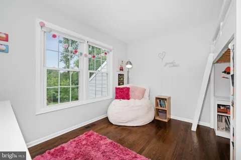 a living room with furniture and a book shelf
