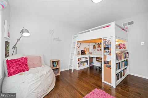 a bedroom with a bed a bed and dresser