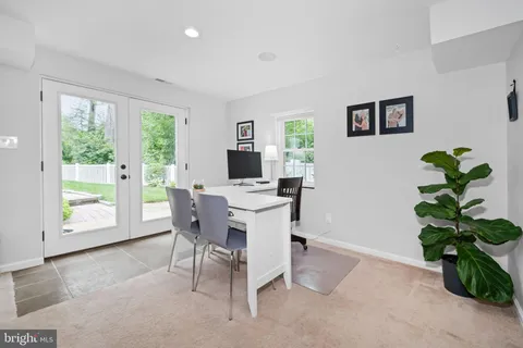 a dining room with furniture and a flat screen tv