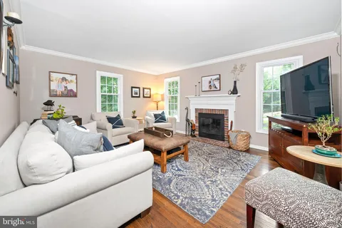 a view of a dining room with furniture a chandelier and wooden floor