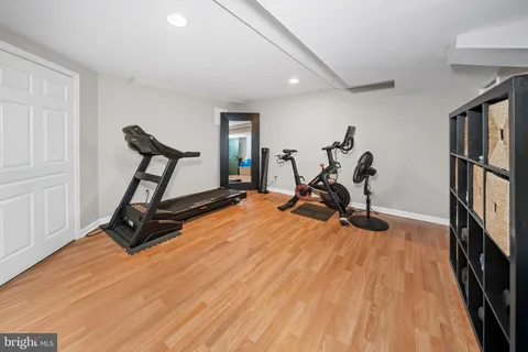 a view of a patio with couches and a table and chairs with wooden fence