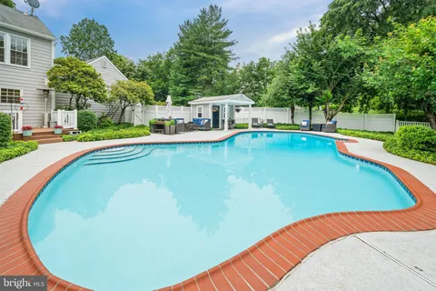 a view of a patio with chair and table and chairs with plants and plants