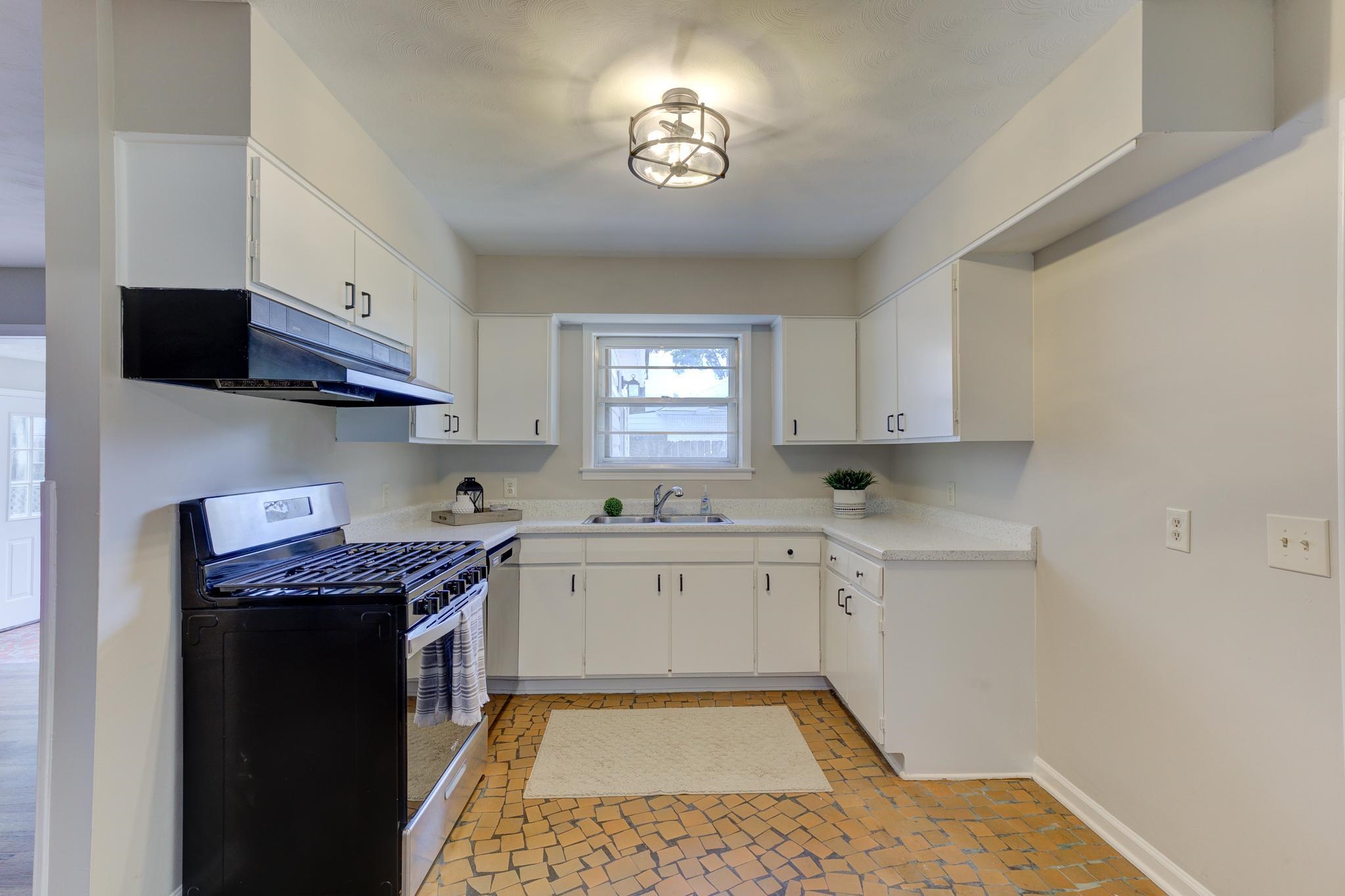 2823 Altruria Road Bartlett, TN 38134 - Photo 13 of 40 a kitchen with stainless steel appliances granite countertop a sink stove and cabinets