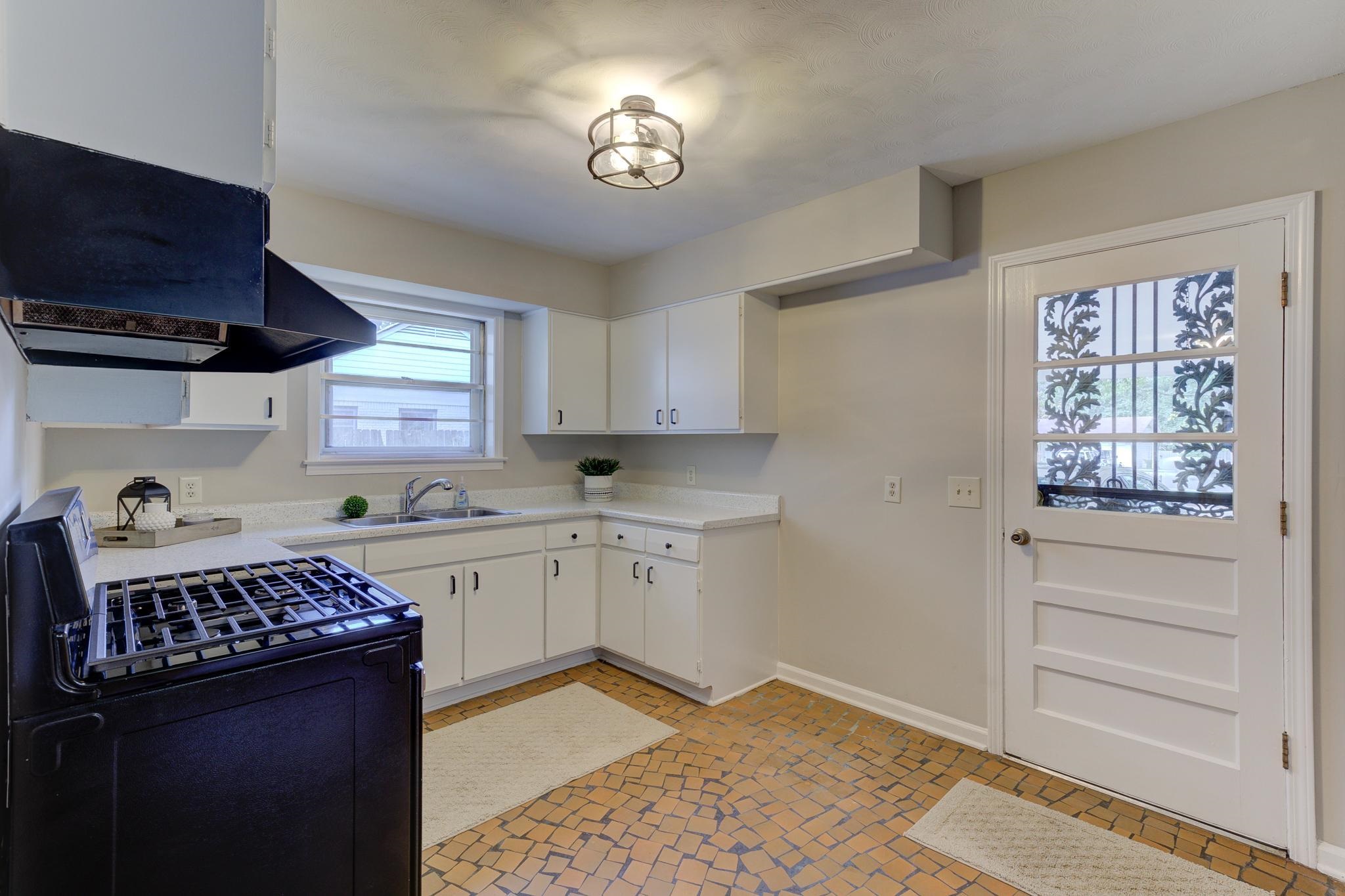 2823 Altruria Road Bartlett, TN 38134 - Photo 14 of 40 a kitchen with a stove a sink and cabinets
