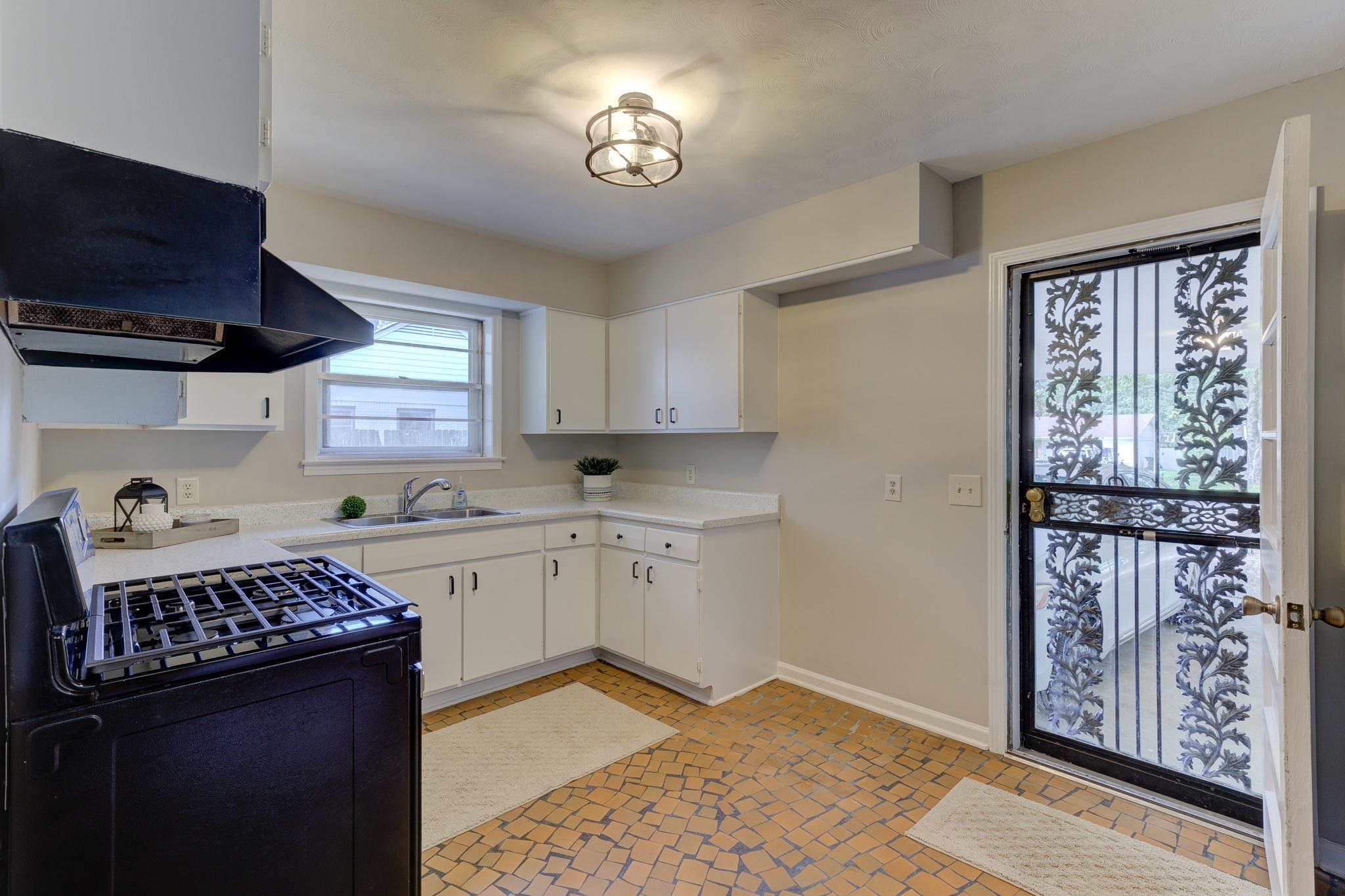 2823 Altruria Road Bartlett, TN 38134 - Photo 17 of 40 a kitchen with a stove a sink and a window
