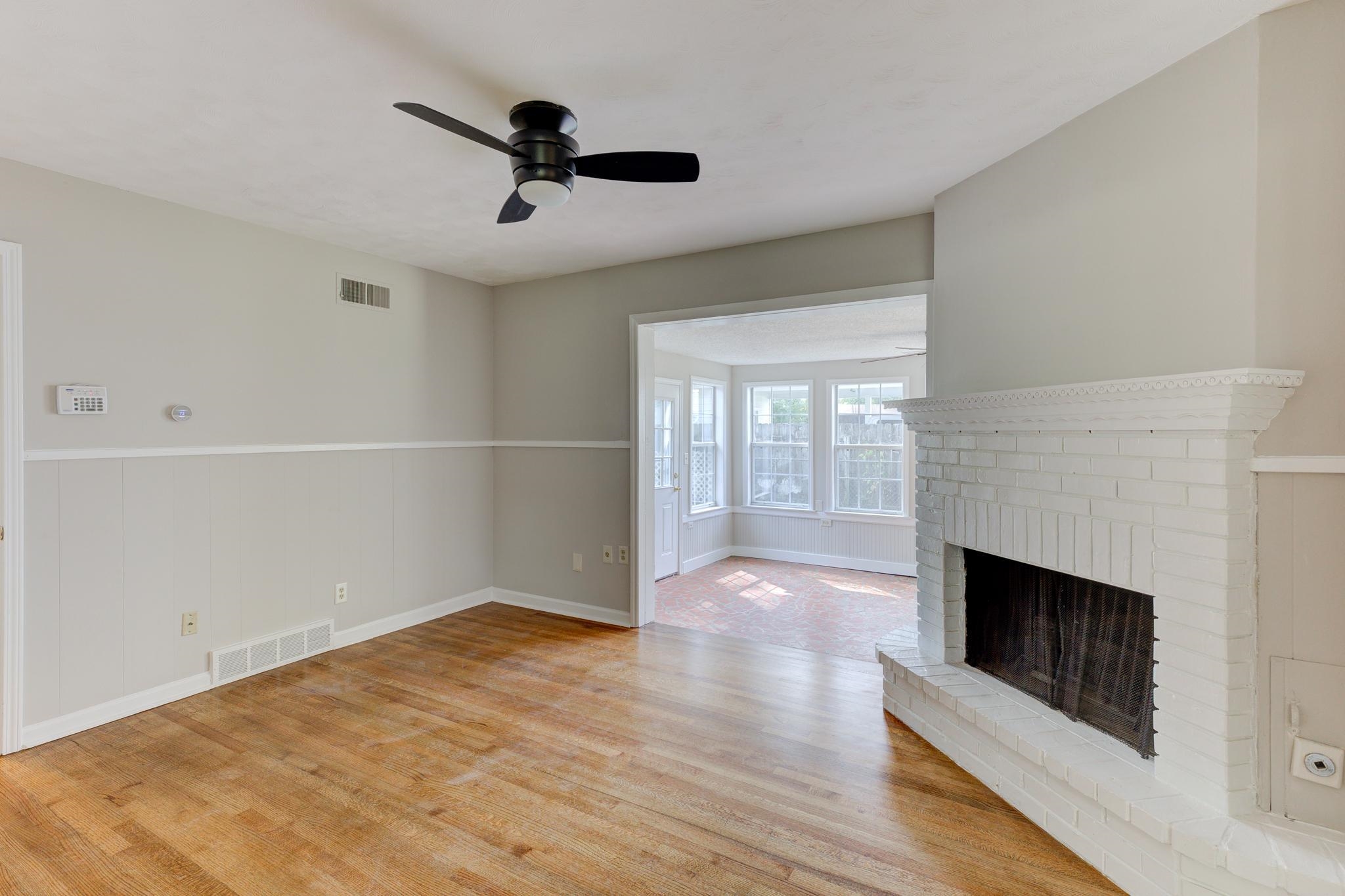 2823 Altruria Road Bartlett, TN 38134 - Photo 4 of 40 wooden floor in an empty room with a fireplace