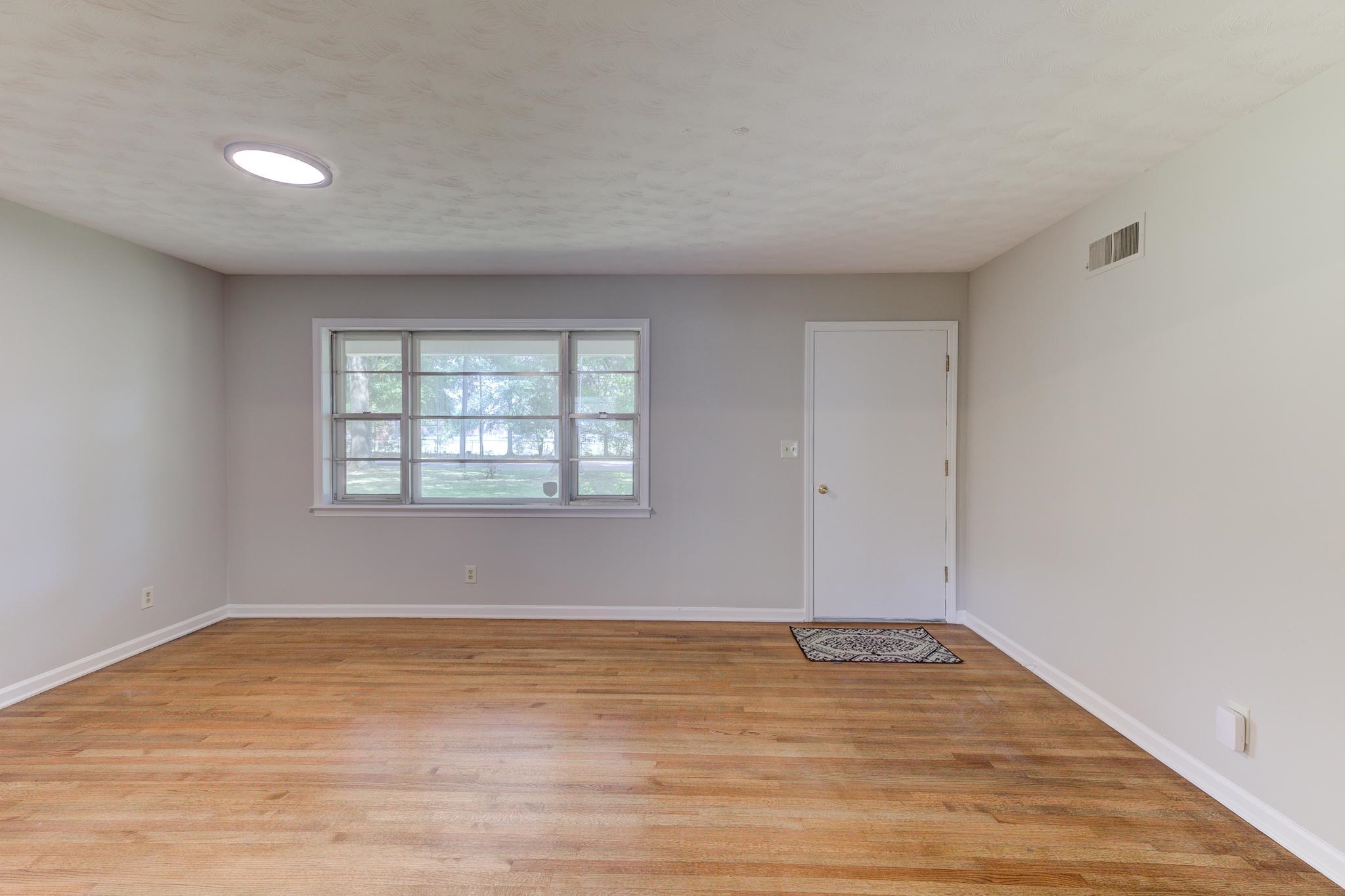 2823 Altruria Road Bartlett, TN 38134 - Photo 8 of 40 an empty room with wooden floor and windows