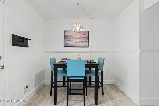 a view of a room that has a table and chairs in it