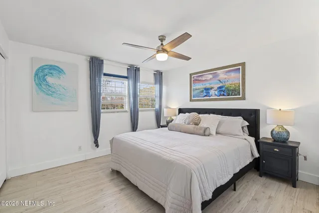 a bedroom with a bed and a painting on the wall