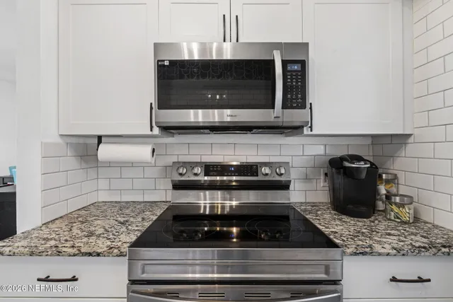 a close view of a sink a faucet and a dishwasher in a bathroom