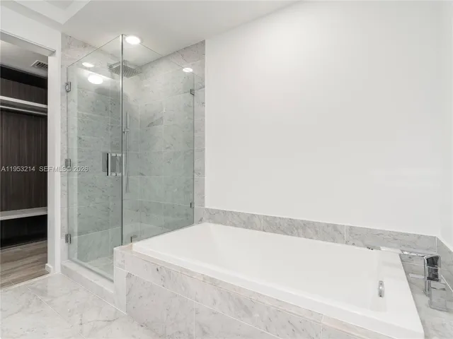 a bathroom with a bathtub and shower