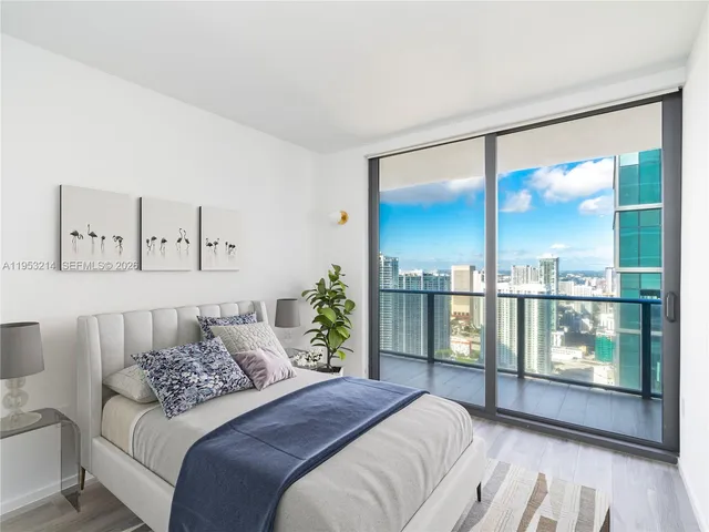 a bedroom with a large bed and a large window