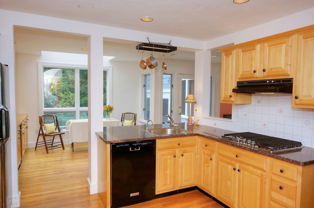 30 Rutledge Road Belmont, MA 02478 - Photo 12 of 30 a kitchen with stainless steel appliances granite countertop a sink a stove and a refrigerator