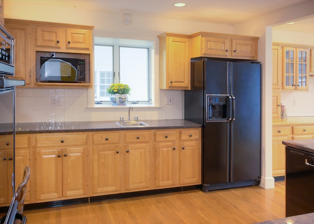 30 Rutledge Road Belmont, MA 02478 - Photo 14 of 30 a kitchen with stainless steel appliances granite countertop a refrigerator a stove and a sink with wooden floor