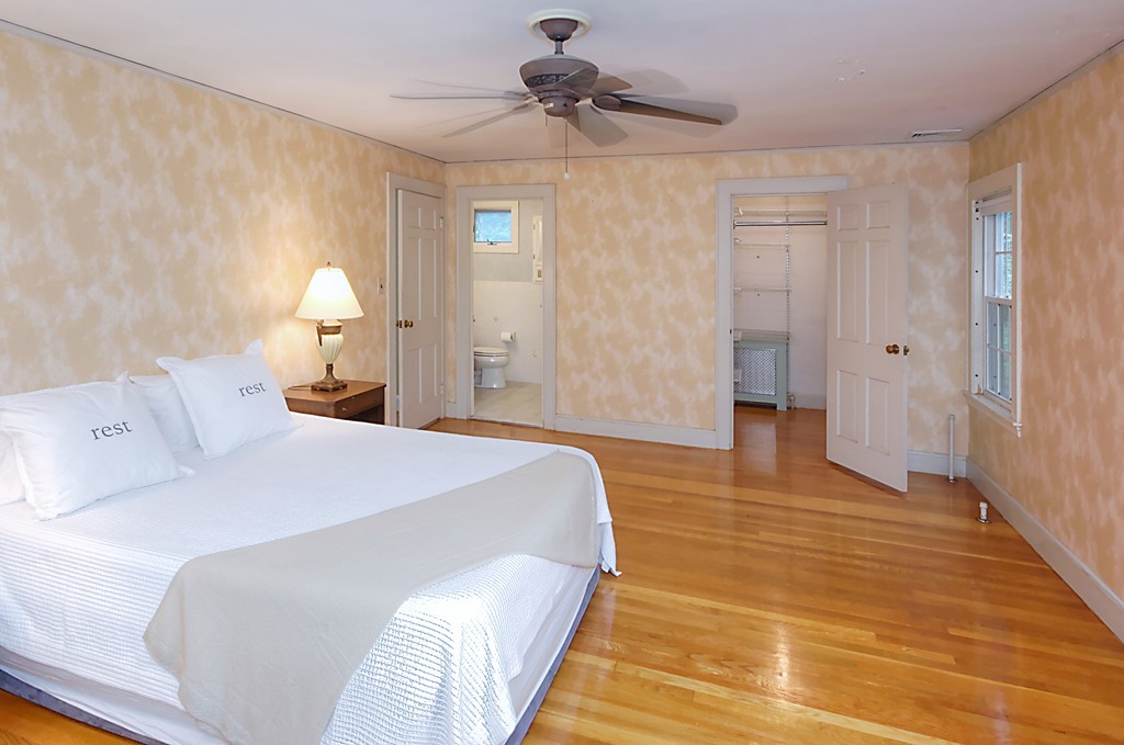 30 Rutledge Road Belmont, MA 02478 - Photo 26 of 30 a bedroom with a bed and a chandelier