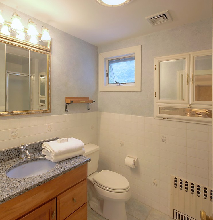 30 Rutledge Road Belmont, MA 02478 - Photo 27 of 30 a bathroom with a granite countertop toilet sink and mirror