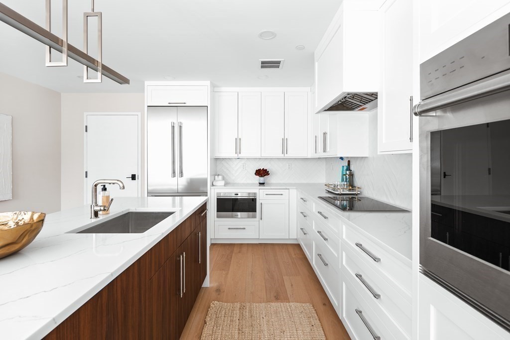 20 Kinmonth Road, Unit 108 Newton, MA 02468 - Photo 6 of 25 a large kitchen with stainless steel appliances lots of counter space and a sink